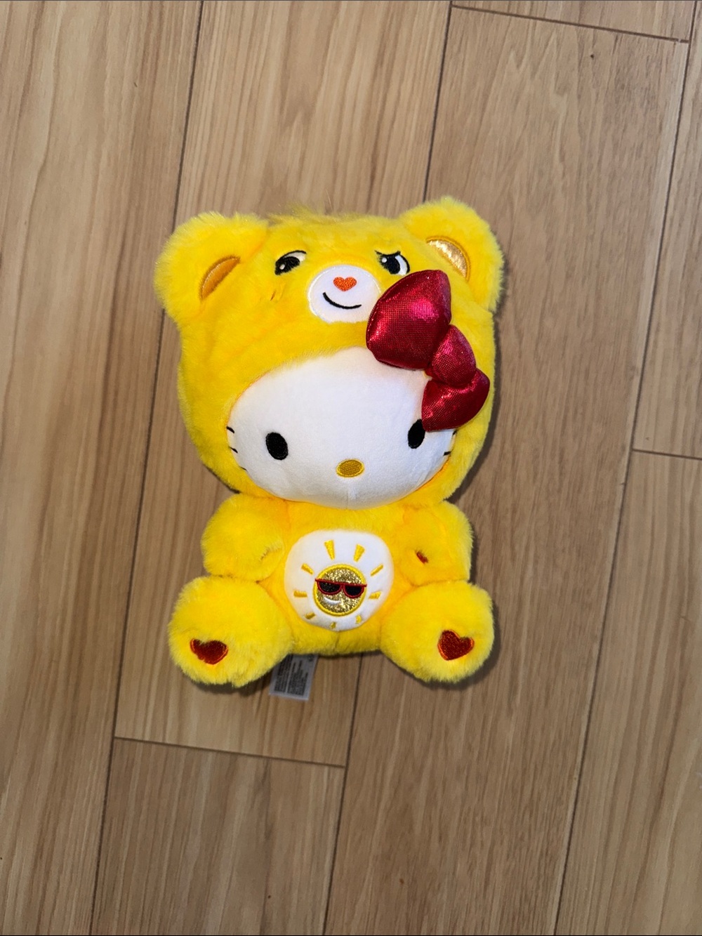 Hello Kitty Dressed as a Yellow Care Bear Plush with Shiny Red Bow